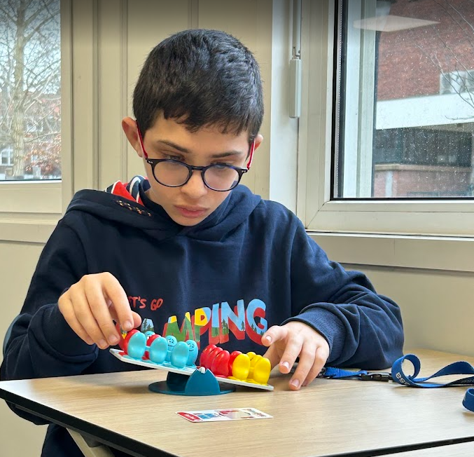 A student building a balance puzzle during a Limitless session