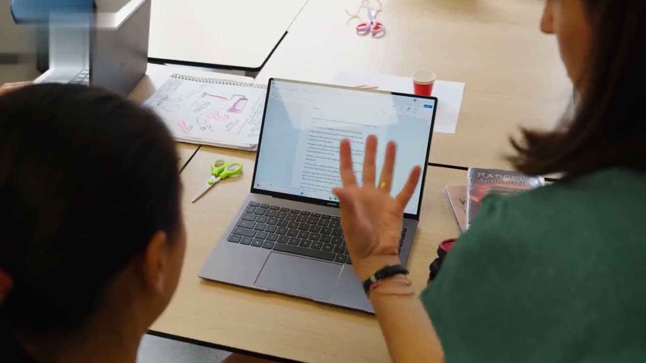 A student working through her project on a laptop